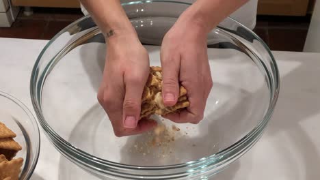 woman preparing biscuit cake in glass bowl