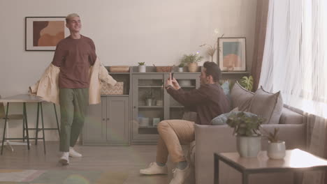 young man shooting on phone his boyfriend singing