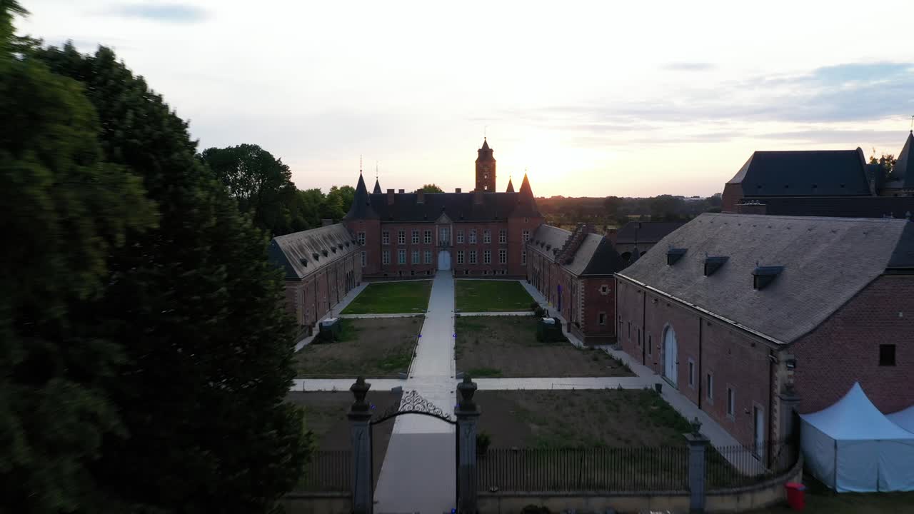 vista aérea de la entrada y el jardín del castillo de alden biesen en bélgica, alemania, repartidos en una gran área con vegetación y paisaje y carpa fuera de la entrada principal durante el día