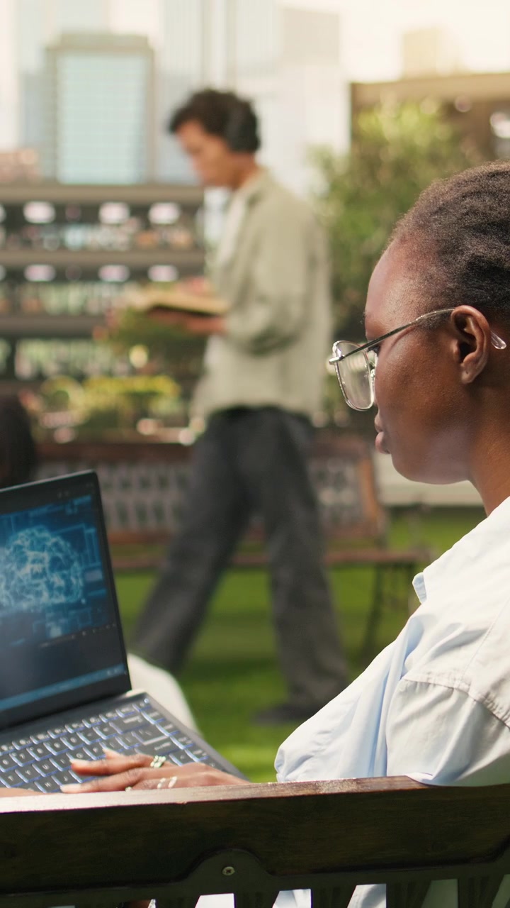 Vertical Video IT engineering student using AI and binary code on laptop screen