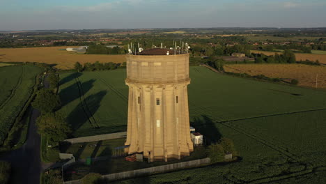 Aerial-footage-of-a-water-tower-on-a-summers-evening