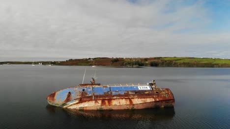 half sunken shipwreck. abandoned ship aerial