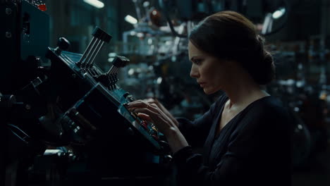 woman working on a complex machine in a factory