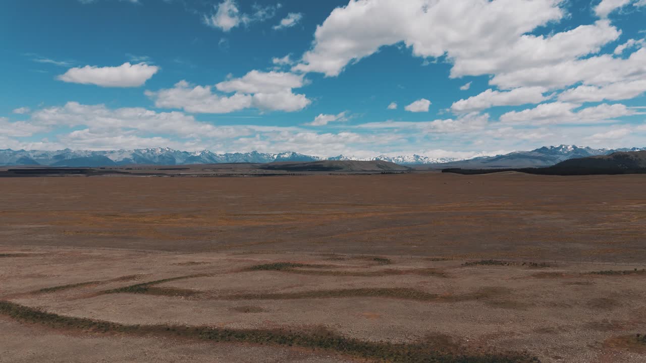 un vasto paisaje desértico desolado con los alpes del sur en la distancia - nueva zelanda