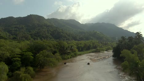atvs crossing shallow water of tuito river in yelapa, jalisco, mexico - aerial drone shot