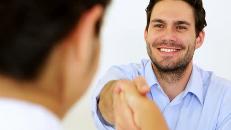 Businessman-shaking-hands-with-job-applicant