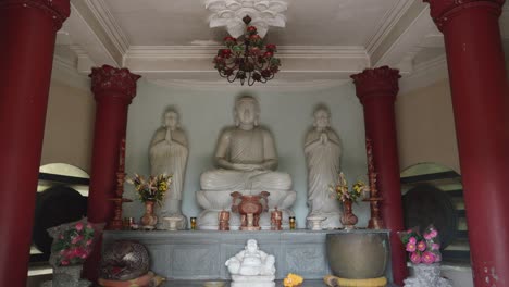 white buddha inside the prayer hall of temple in vietnam