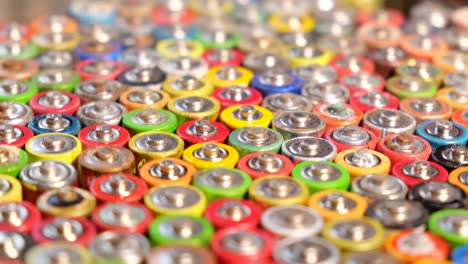 old used discarded aa cells and other electric batteries from old used discarded aa cells and other electric batteries from different manufacturers waste waste collection and recycling high risk they rotate on the turntable around their axis movement