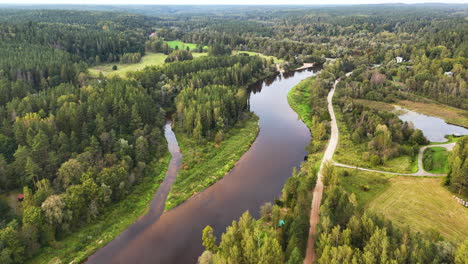 4K Aerial Birds Eye Flyover Gauja National Park, Latvia. Drone Flying Over A Paved Pedestrian Trail And Bike Path Running Parallel To The Famous Gauja River.