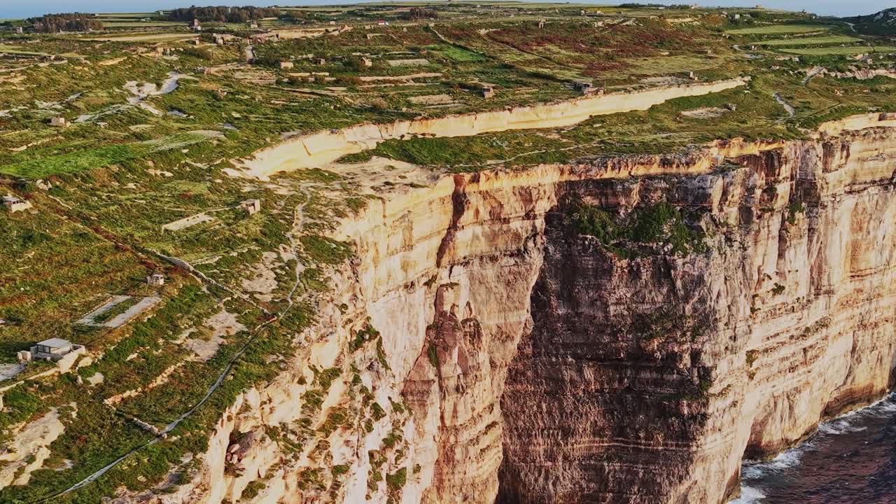 Cliffs and fields at the coast of malta during daylight hours