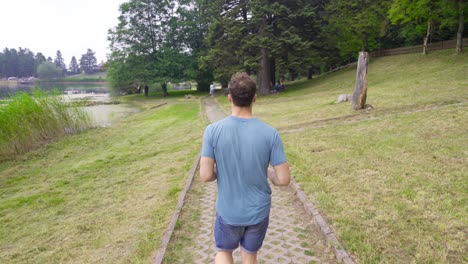 man jogging in nature park.