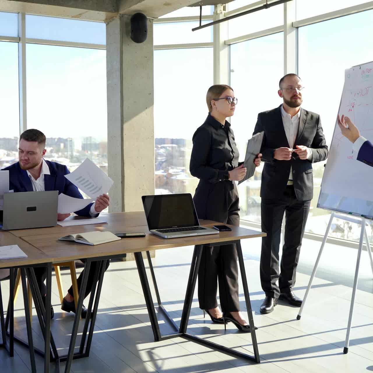Creative team discussing new project. Group of young business people working and communicating together in creative office