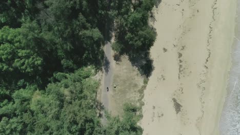 Birds-eye-view-aerial-shot-of-a-beautiful-exotic-beach-with-sand-and-sea