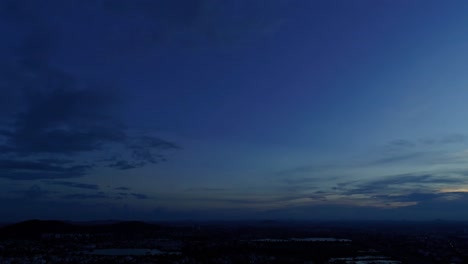 aerial footage for blue hour during sunset revealing city lights and a highway