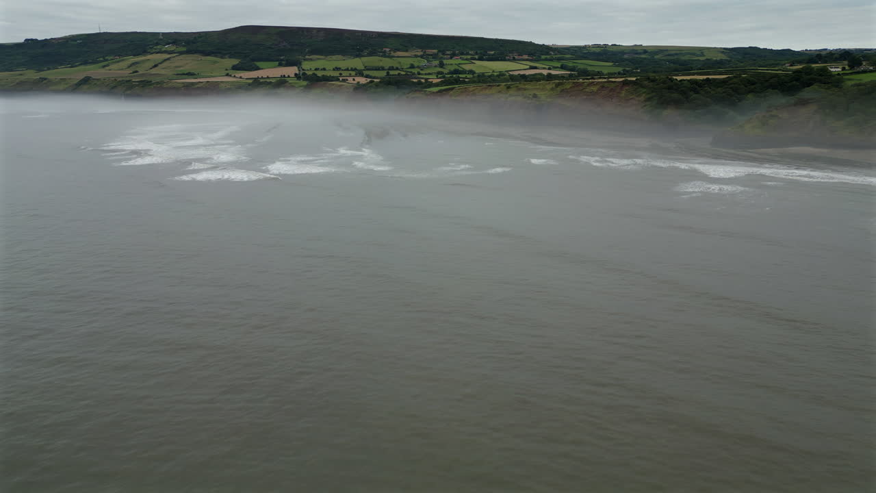 Rotating Aerial Drone Shot of North Yorkshire Coast in the Mist Near Robin Hood's Bay