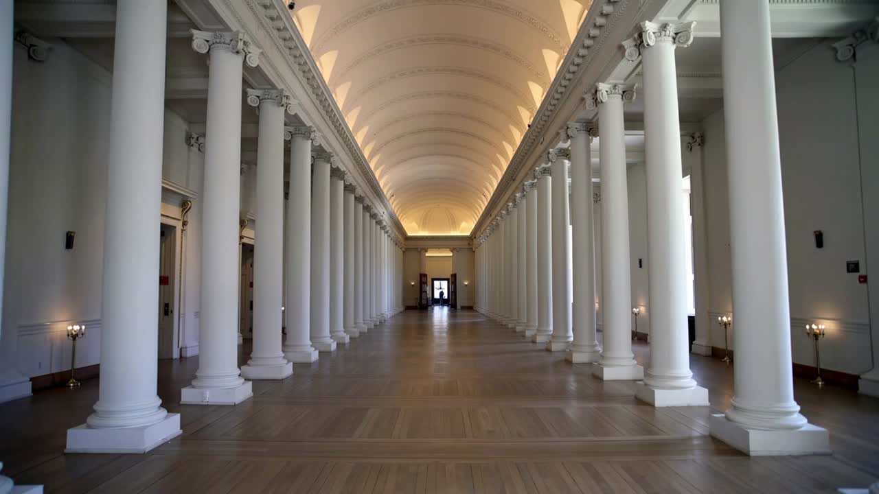 Starting slow forward tracking, camera showing central columns in grand hall, exposing lit doorway