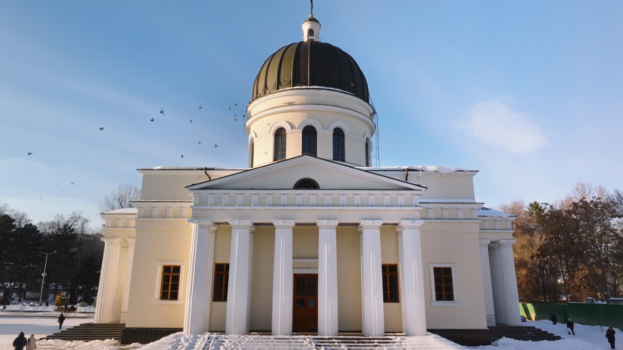 Aerial drone view of the Metropolitan Cathedral of Christ's Nativity. City center covered in snow at sunset in Chisinau, Moldova