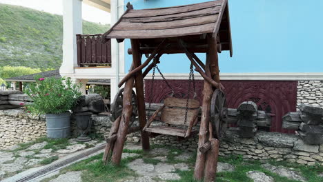 panoramic handheld shot: the elegance of empty abandoned wooden swing at rustic surroundings