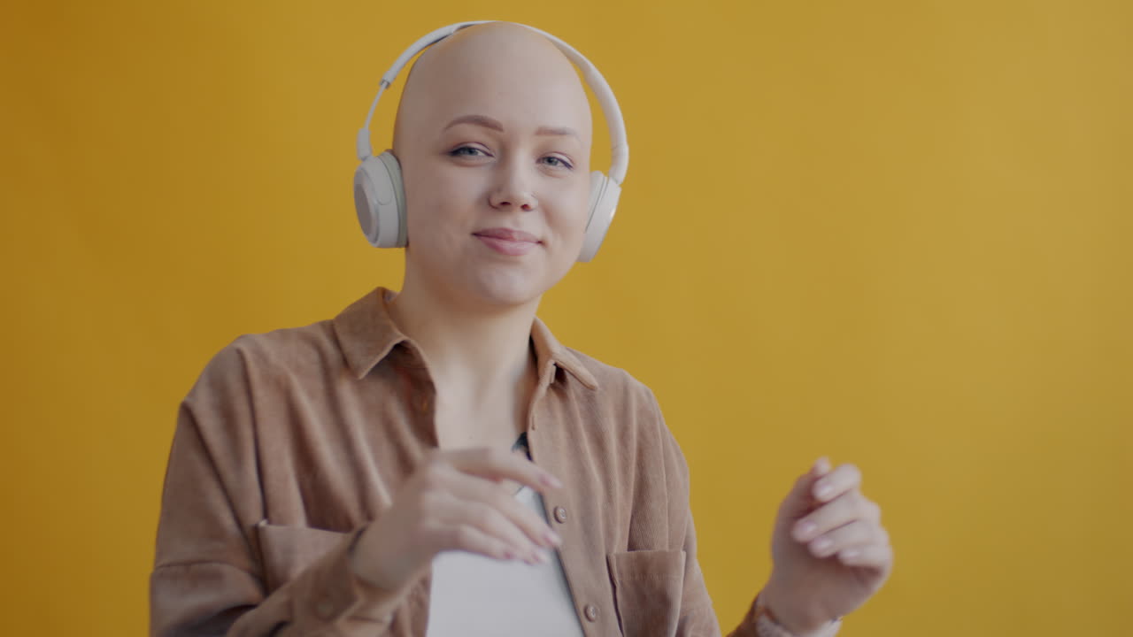 Woman with Headphones, Smiling and Listening to Music