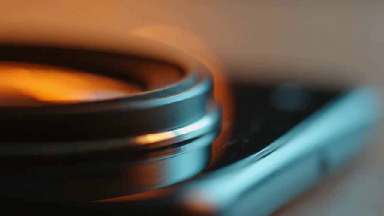 A Close-Up Perspective of a Smartphone Lens with Beautiful Bokeh Effects Featuring Soft Warm Light and Reflective Surfaces in an Artistic Setting