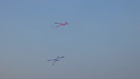 kite soars and dips against twilight backdrop.