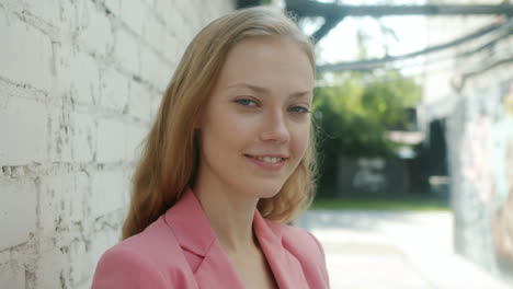young woman in pink blazer
