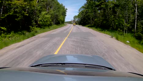 driving behind a yellow pickup truck on back road, wide sunroof pov in 4k 60fps