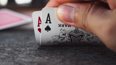 Close-Up-Unveiling-Two-Aces-Held-in-Hand