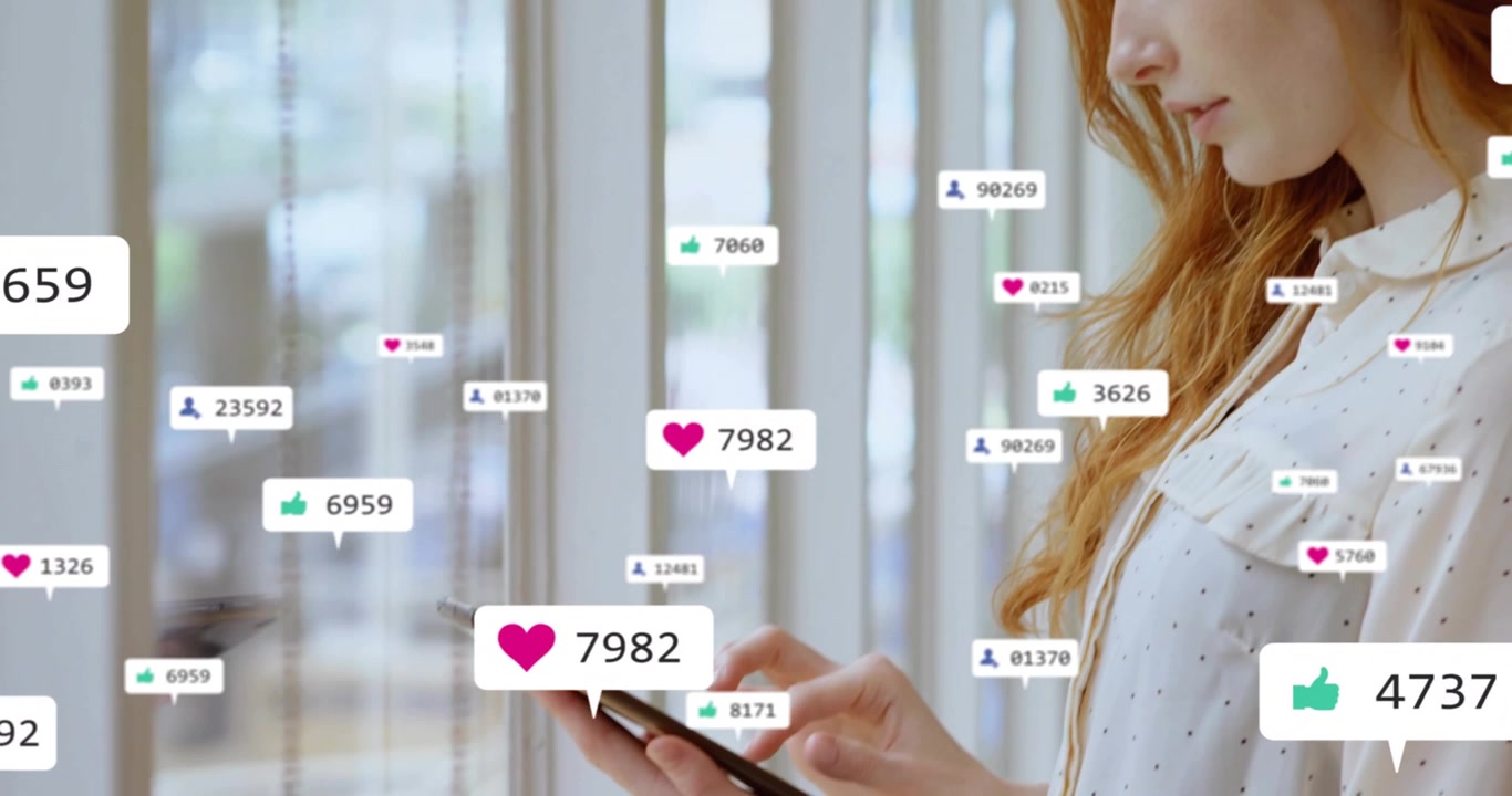Woman reacting to social media alerts lifting device and tapping spawning heart and follower badges