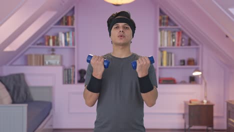 indian man lifting dumbells and doing exercise