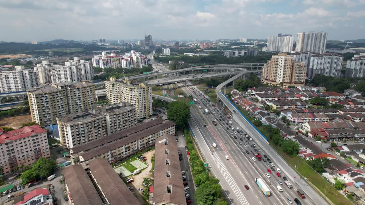 Busy streets on a highway intersection at Sri Petaling in Kuala Lumpur, Malaysia, busy streets and traffic jams on a lovely day. Result of great infrastructure investment in this asian megacity