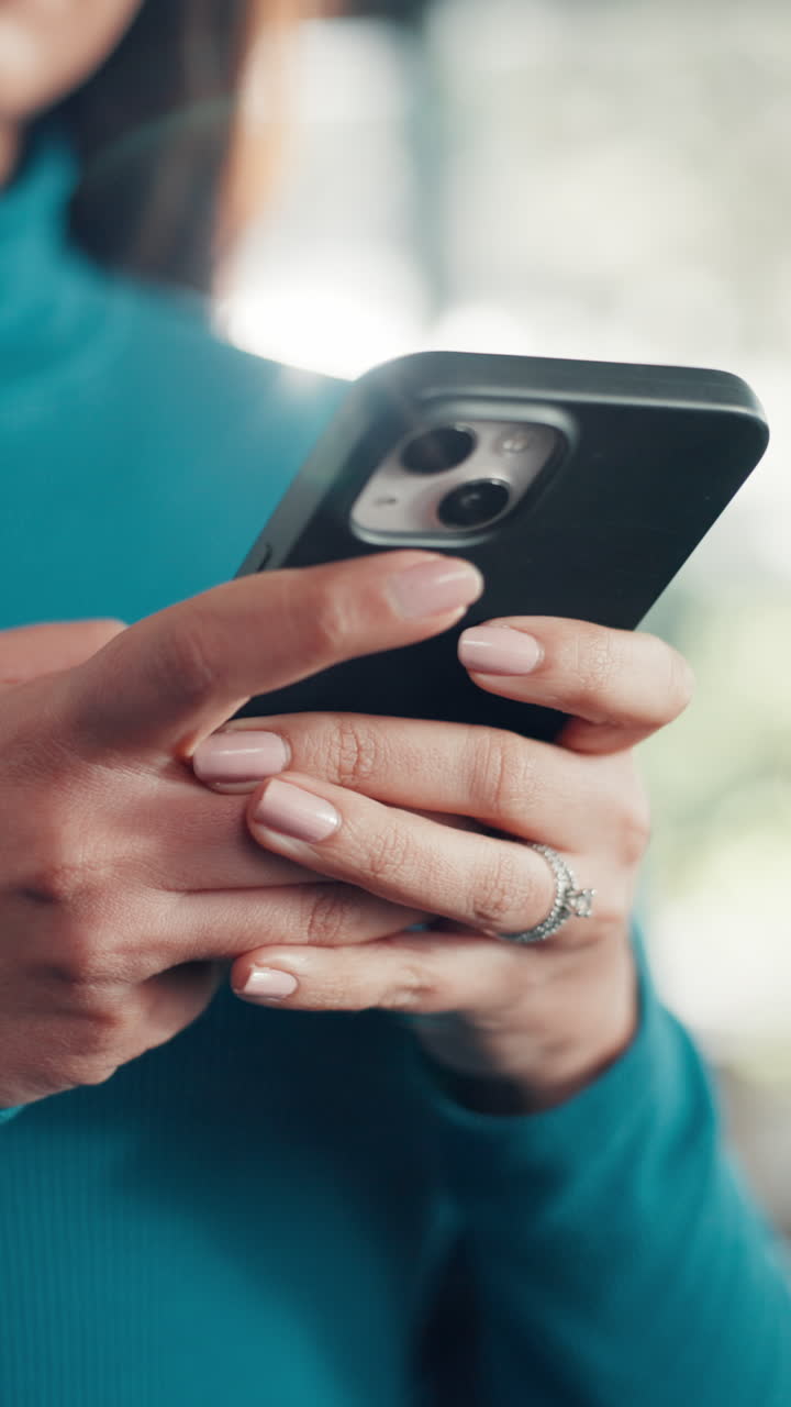 Close-up of Woman's Hands Scrolling on a Smartphone