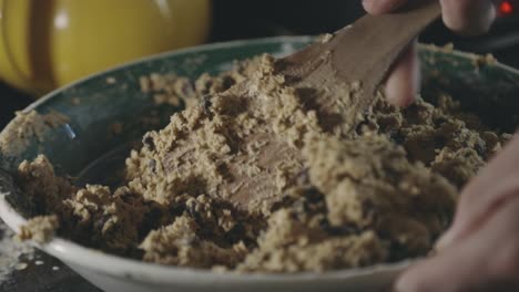 mixing cookie mixture with chocolate chips in a bowl - close up