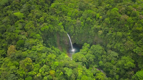 paradise tropical waterfall hidden in lush green jungle of costa rica, fortuna