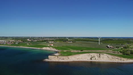 Antena-De-La-Costa-Danesa-En-Un-Caluroso-Día-De-Verano-Con-Campos-Verdes-Y-Mar-En-Calma