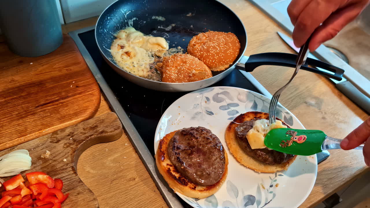 Cooking Juicy Homemade Burgers on a Hot Stove With Ingredients Prepared for Assembly
