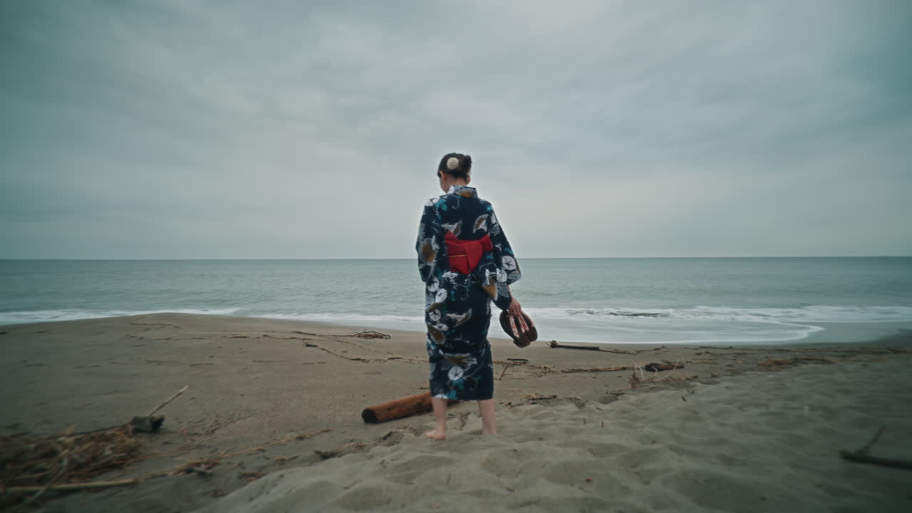 Woman in Kimono Walking on the Beach