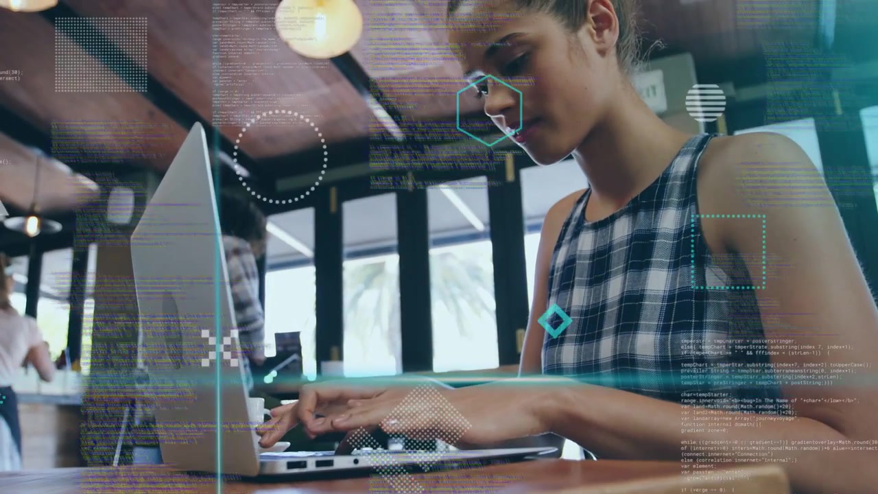 Woman typing on laptop in cafe, causing HUD overlay visualizing technology data for work