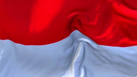 bandera de indonesia ondeando en el viento animación en cámara lenta. 4k textura de tela realista bandera soplando suavemente en un día de viento fondo de bucle continuo sin costuras.