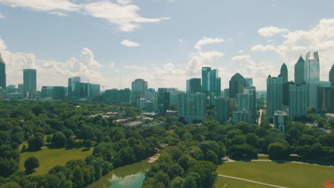 beautiful drone footage of piedmont park and the atlanta skyline on a sunny day