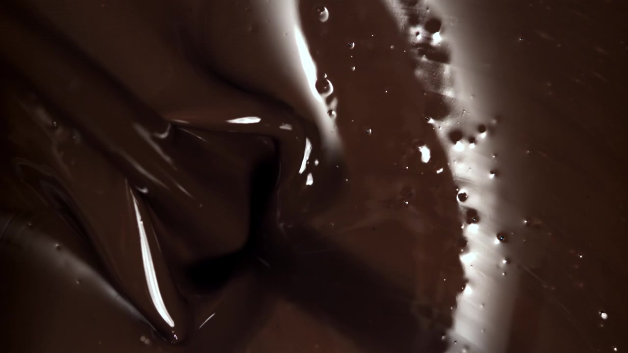 Chocolate cremoso derretido removiéndose en cámara lenta