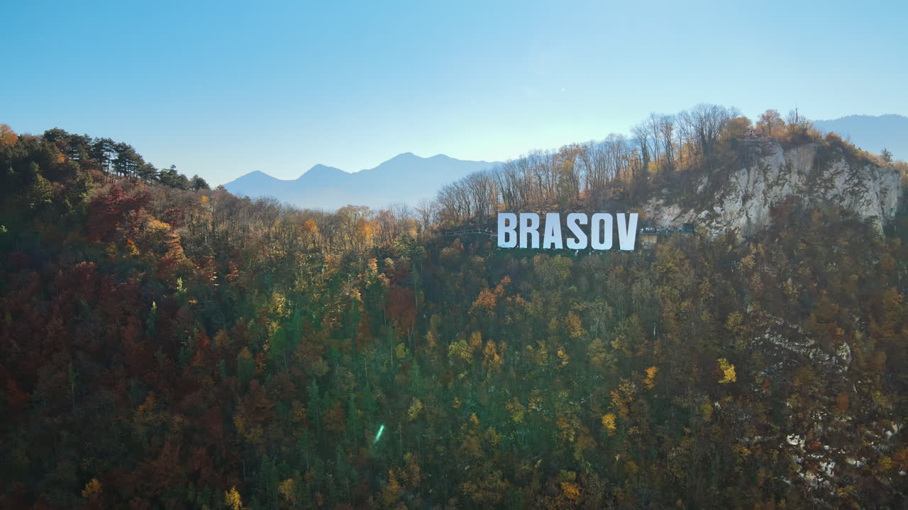 Brasov sign on the top of the hill near the city, yellowed trees, Romania