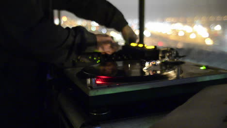 Rack-focus-on-a-disc-Jockey-spinning-records-and-playing-music-at-a-nightclub-in-San-Diego-California