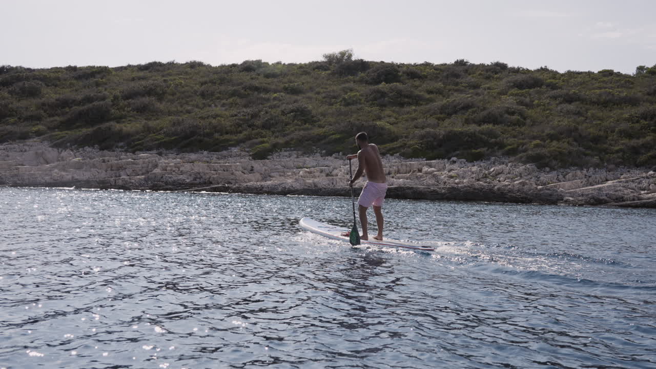 Man Stand-Up Paddleboarding in the Ocean