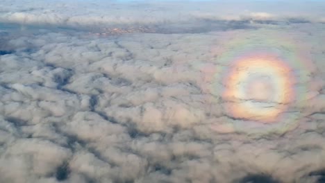 Aerial-shot-of-rare-and-unique-circle-halo-rainbow-effect-over-the-clouds