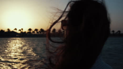 portrait of calm woman walking along coastline. young woman meditating at beach