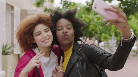 portrait-of-two-young-beautiful-woman-friends-posing-making-faces-taking-selfie-photo-using-smartphone-enjoying-friendship-connection