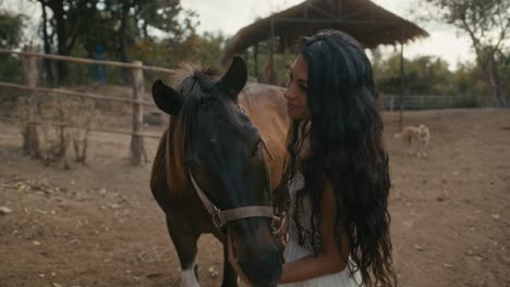 woman and horse share a tender moment outdoors