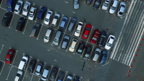 Drone-flying-over-parking-near-mall.-Copter-filming-people-walking-at-parking