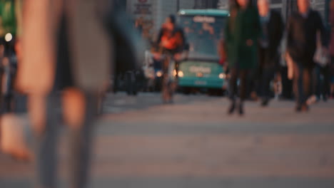 anonymous crowd of people walking cycling bicycles commuters london city street slow motion